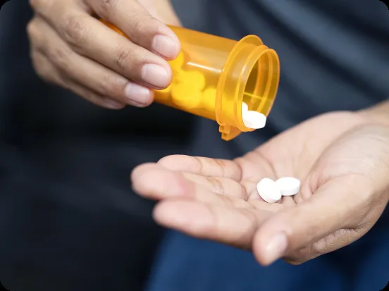 person-holding-pills person-holding-pills
